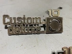 Front Fender "custom Deluxe 10" Emblem 1975-1980 Chevy Pickup Trucks 14016633. Fixed Price $50.00.