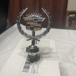 1985,89 Cadillac Brougham Deville Fleetwood Wreath Hood Ornament. Fixed Price $220.00.